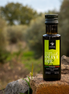 ITALOIL 100ml extra virgin olive oil bottle in an Italian olive grove