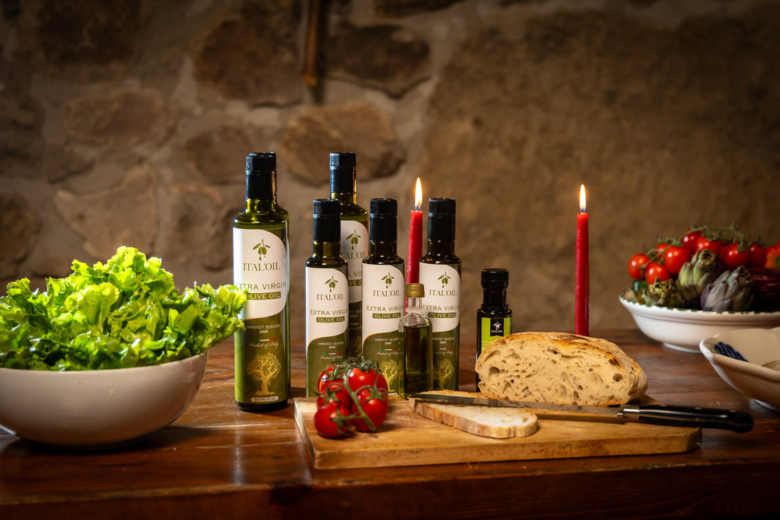 ITALOIL olive oil bottle collection with bread, tomatoes, artichokes, and salad