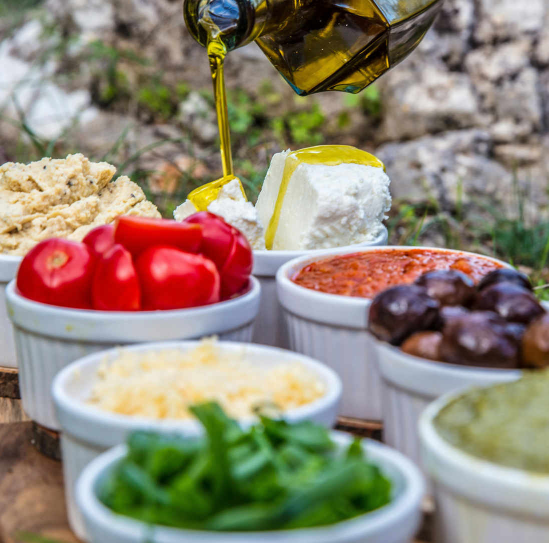 Italian antipasto spread paired with extra virgin olive oil