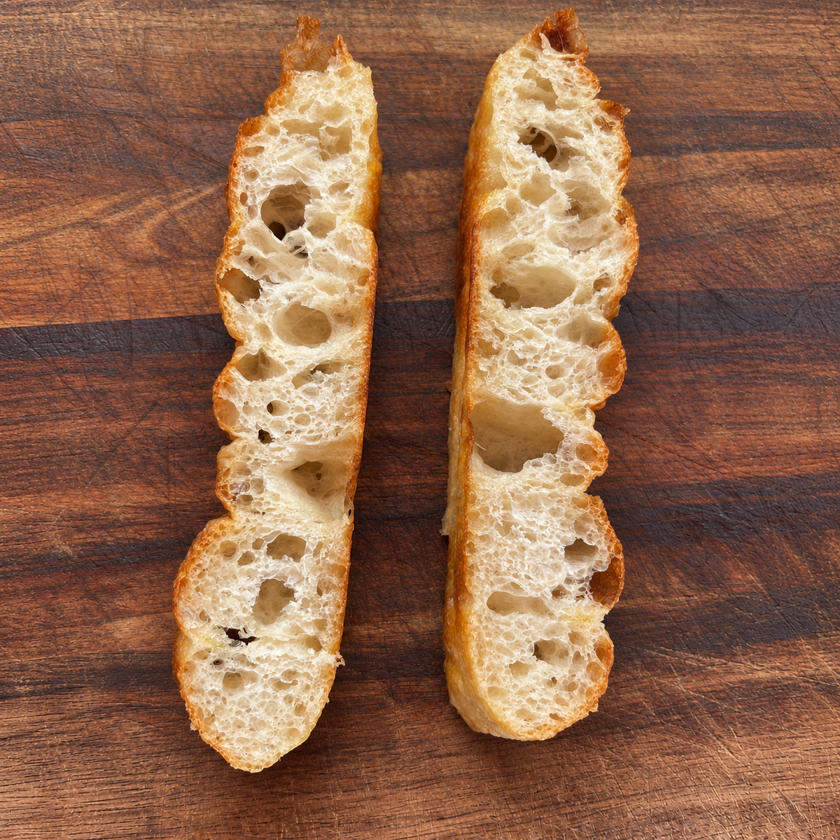 Sliced ITALOIL focaccia showing its open airy crumb and crisp crust