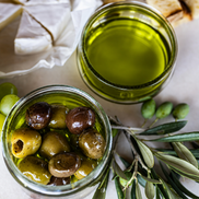 Bright green olive oil with harvested olives