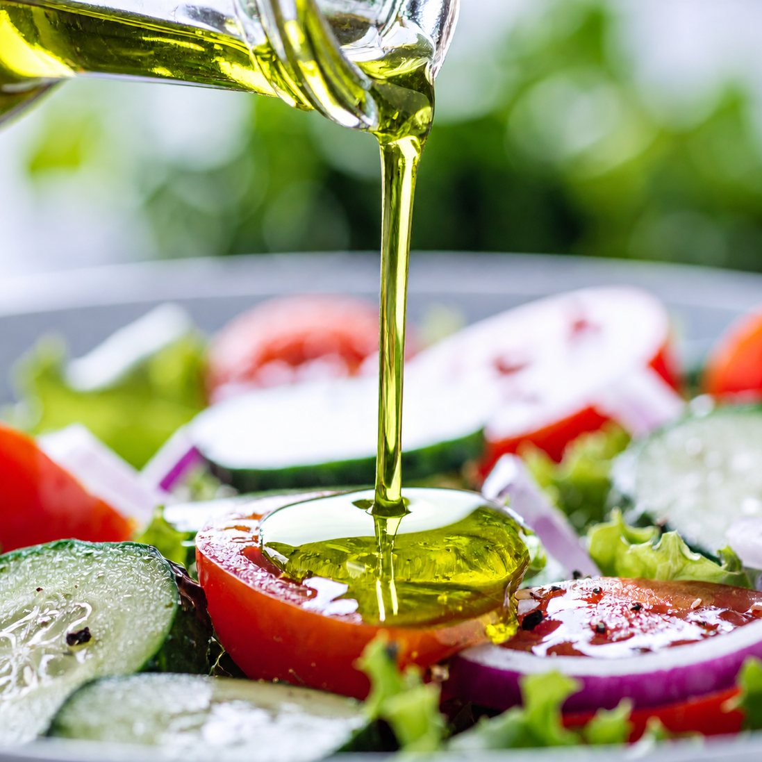 Bright green olive oil on a fresh salad