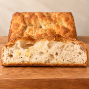 Square ITALOIL olive oil focaccia cross-section with airy crumb and golden crust