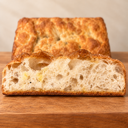 Square ITALOIL olive oil focaccia cross-section with airy crumb and golden crust